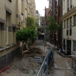 a narrow city street with lots of buildings